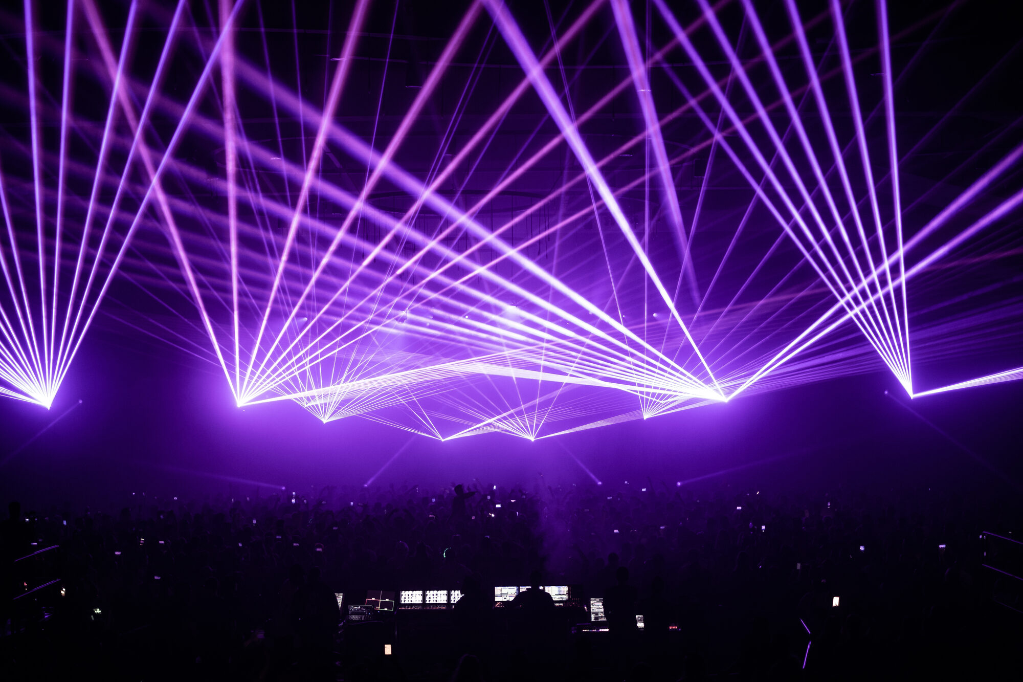 Purple laser beams fanning across a stage, Laser Spectacles