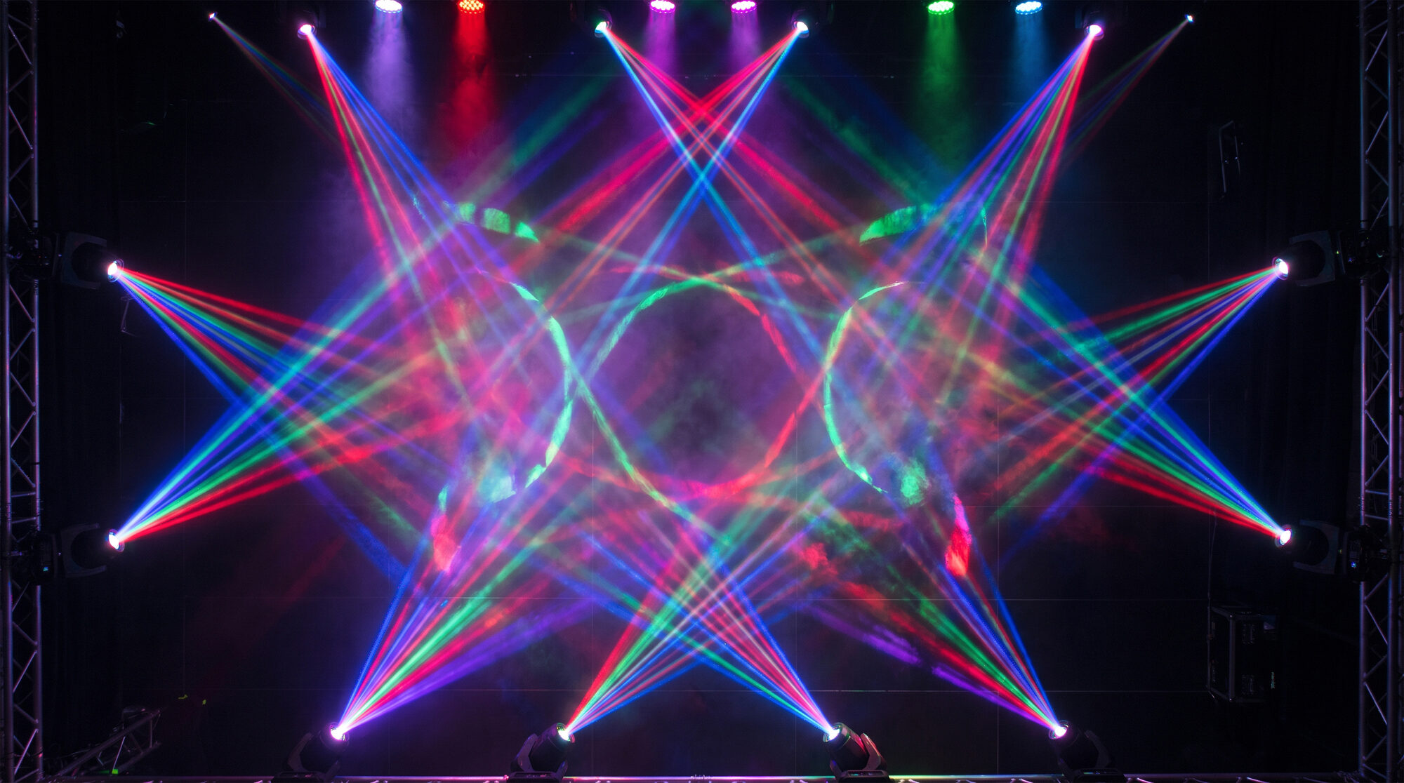 Crisscrossing red, green and blue laser beams forming a pattern on stage, Laser Spectacles