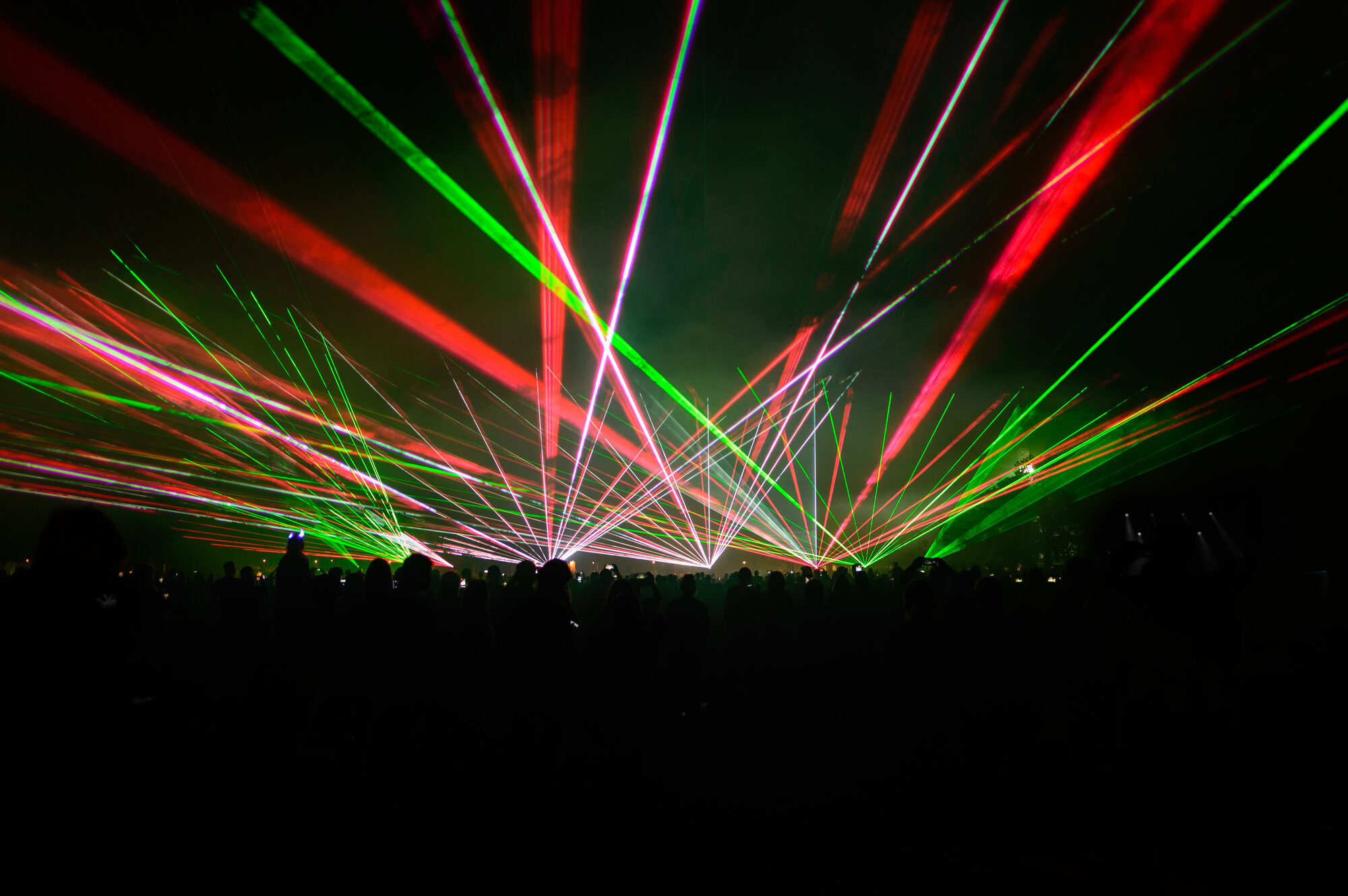 Red and green laser beams over a crowd, Laser Spectacles
