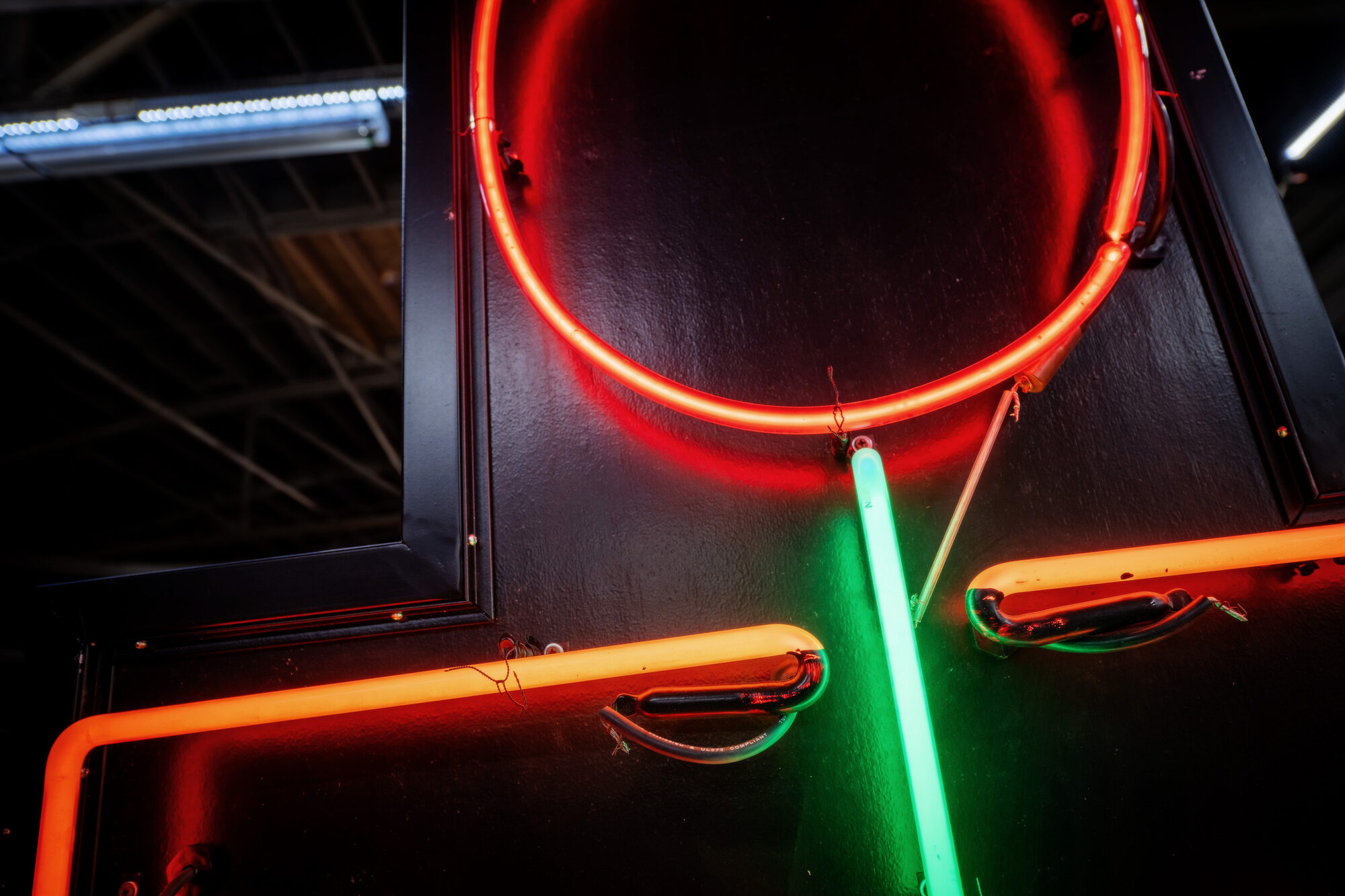 Neon artwork by Larry Simmons and Tony Greer, red neon circle with orange and green tubes