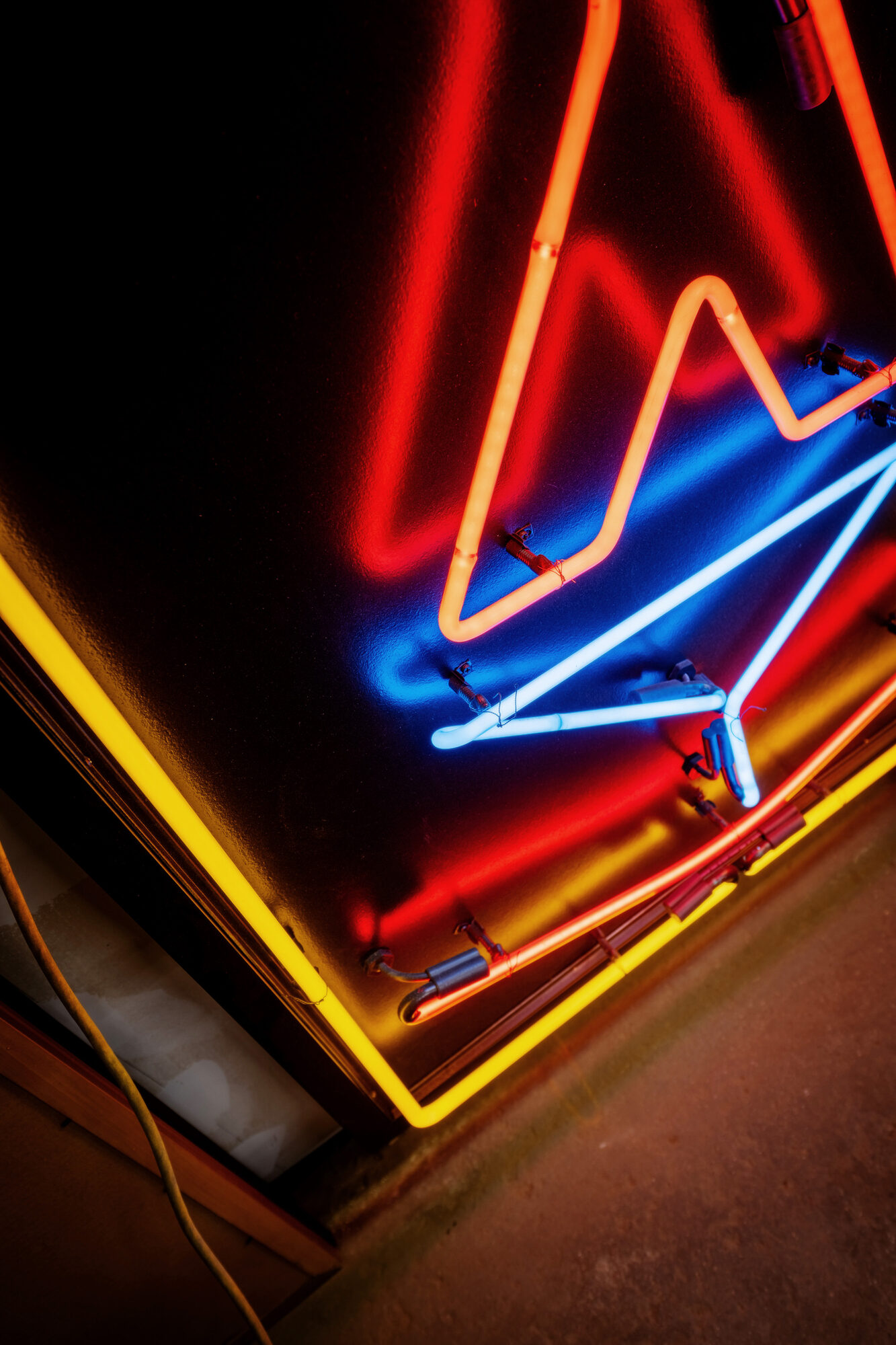 Neon artwork by Larry Simmons and Tony Greer, red, blue and yellow neon angles