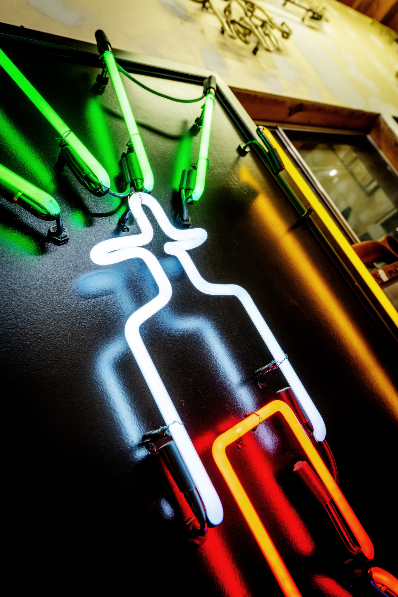 Neon artwork by Larry Simmons and Tony Greer, white and orange neon sculpture